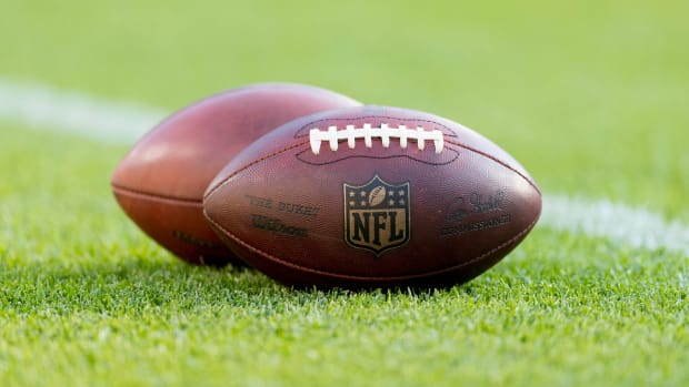 NFL footballs sit on the turf prior to the game between the Tennessee Titans and Green Bay Packers at Lambeau Field.