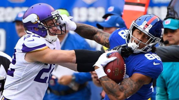 Oct 6, 2019; East Rutherford, NJ, USA; New York Giants tight end Evan Engram (88) gets a first down in the first quarter as Minnesota Vikings free safety Harrison Smith (22) defends at MetLife Stadium.