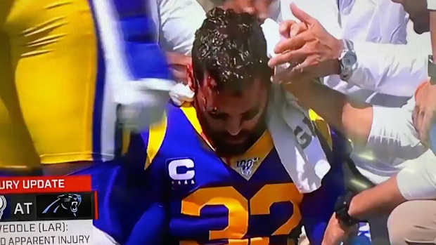 eric-weddle-christian-mccaffrey-knee-bleeding.jpg
