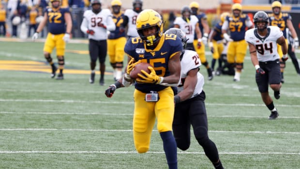 West Virginia wide receiver George Campbell hauls in a 34-yard touchdown pass from Jarrett Doege