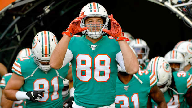 Dolphins tight end Mike Gesicki leads team onto field.