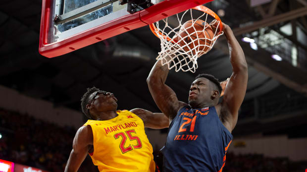 Illinois Fighting Illini center Kofi Cockburn (21) dunks as Maryland Terrapins forward Jalen Smith (25) defends during the first half at XFINITY Center.