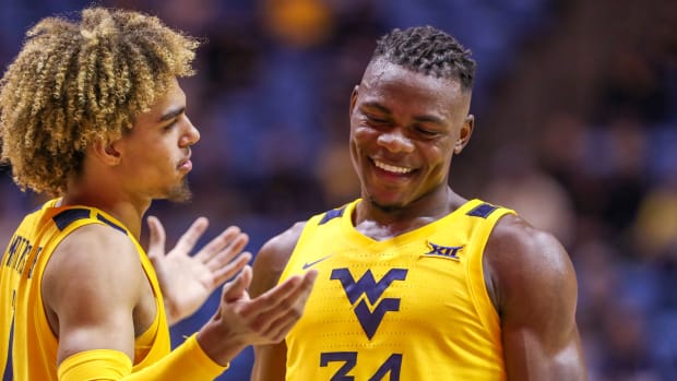West Virginia Mountaineers forward Emmitt Matthews Jr. (11) and West Virginia Mountaineers forward Oscar Tshiebwe (34) talk late in the second half against the Austin Peay Governors at WVU Coliseum.