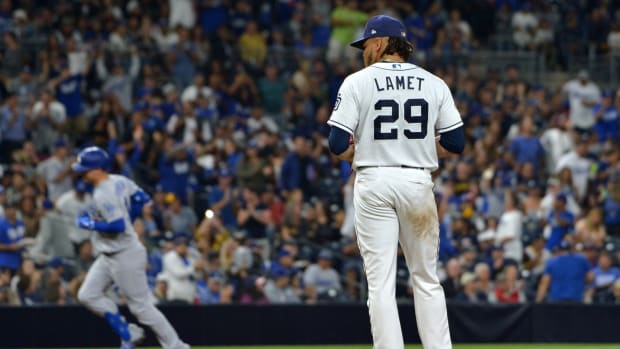 Sep 25, 2019; San Diego, CA, USA; San Diego Padres starting pitcher Dinelson Lamet (29) reacts after giving up a solo home run to Los Angeles Dodgers right fielder Joc Pederson (background) during the fifth inning at Petco Park. Mandatory Credit: Jake Roth-USA TODAY Sports