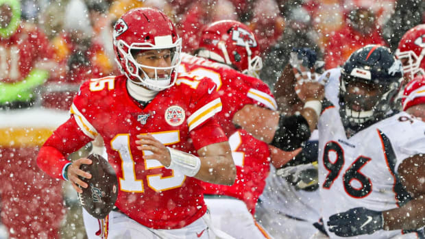Dec 15, 2019; Kansas City, MO, USA; Kansas City Chiefs quarterback Patrick Mahomes (15) scrambles from Denver Broncos defensive tackle Shelby Harris (96) during the second half at Arrowhead Stadium. Mandatory Credit: Jay Biggerstaff-USA TODAY Sports