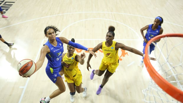 Satou Sabally jumps in the air with the basketball