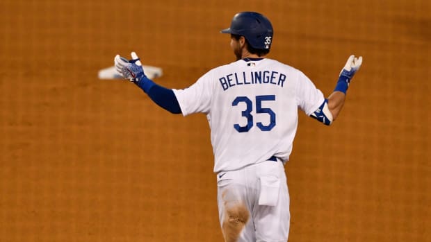 Aug 22, 2020; Los Angeles, California, USA; Los Angeles Dodgers center fielder Cody Bellinger (35) rounds the bases unsure if his deep flyball to right field was called a home run in the ninth inning at Dodger Stadium. Bellinger's blast was called a homer as the Dodgers defeated the Colorado Rockies 4-3 Mandatory Credit: Robert Hanashiro-USA TODAY Sports