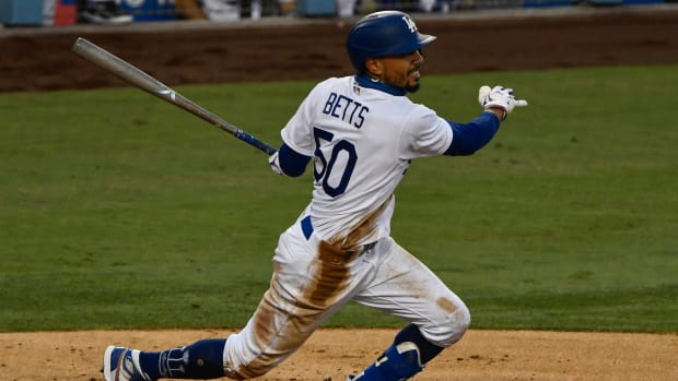 Sep 5, 2020; Los Angeles, California, USA; Los Angeles Dodgers right fielder Mookie Betts (50) singles in the third inning against the Colorado Rockies at Dodger Stadium. Mandatory Credit: Robert Hanashiro-USA TODAY Sports