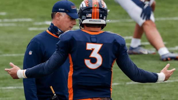 Denver Broncos quarterback Drew Lock (3) with offensive coordinator Pat Shurmur during practice at UCHealth Training Center.