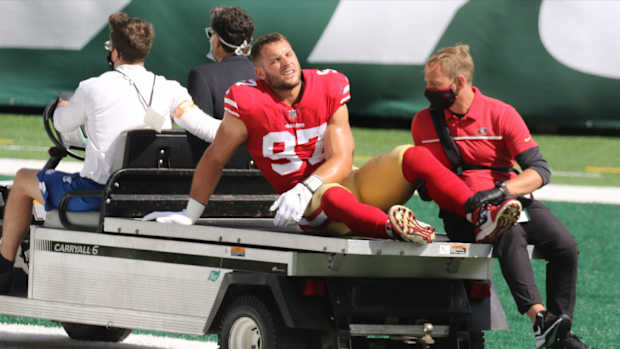 San Francisco 49ers defensive end Nick Bosa is carted off the field Sunday after suffering a torn anterior cruciate ligament in his knee.