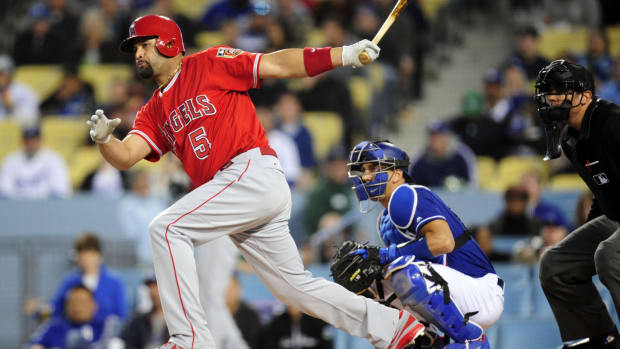 March 26, 2018; Los Angeles, CA, USA; Los Angeles Angels first baseman Albert Pujols (5) hits a single during the first inning against the Los Angeles Dodgers at Dodger Stadium. Mandatory Credit: Gary A. Vasquez-USA TODAY Sports