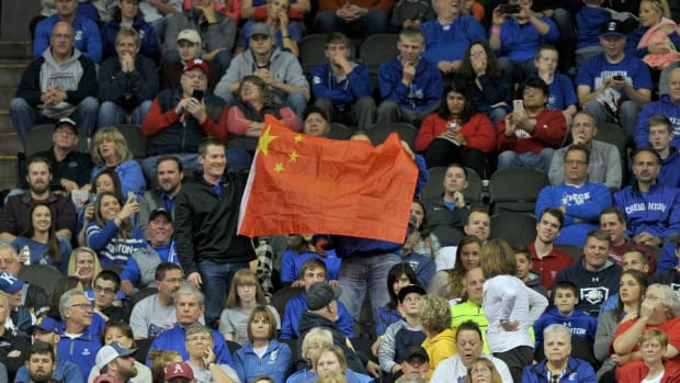 Fans hold up a Chinese flag during the first half of the game between the UCLA Bruins and Creighton Bluejays at Sprint Center.