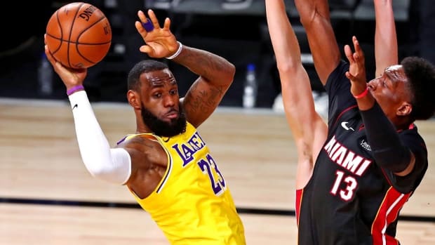Los Angeles Lakers forward LeBron James (23) passes the ball against Miami Heat forward Bam Adebayo (13) during the third quarter in game one of the 2020 NBA Finals at AdventHealth Arena.