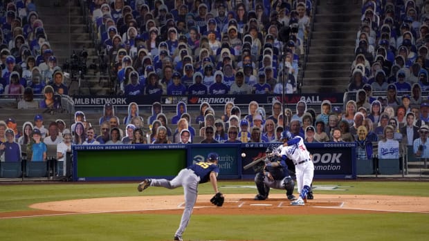 Sep 30, 2020; Los Angeles, California, USA; A general view as Los Angeles Dodgers right fielder Mookie Betts (50) follows through on a double against Milwaukee Brewers relief pitcher Brent Suter (35) in the first inning as Brewers catcher Omar Narvaez (10) and umpire Mark Ripperger (90) watch during Game 1 of the National League Wild Card Playoffs at Dodger Stadium. Mandatory Credit: Kirby Lee-USA TODAY Sports