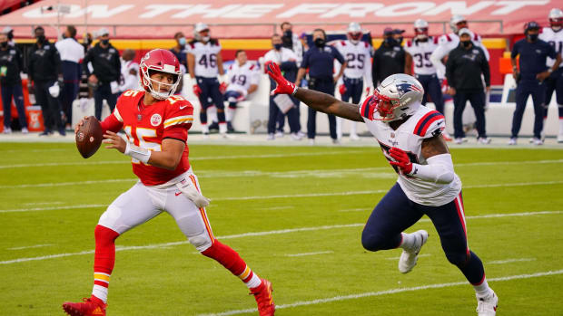Oct 5, 2020; Kansas City, Missouri, USA; Kansas City Chiefs quarterback Patrick Mahomes (15) runs away from New England Patriots pressure during the first quarter of a NFL game at Arrowhead Stadium. Mandatory Credit: Jay Biggerstaff-USA TODAY Sports