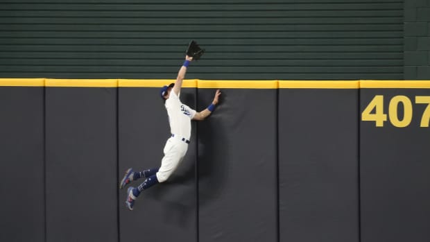 Oct 7, 2020; Arlington, Texas, USA; Los Angeles Dodgers center fielder Cody Bellinger (35) leaps at the wall and robs a home run from San Diego Padres shortstop Fernando Tatis Jr. (not pictured) during the seventh inning in game two of the 2020 NLDS at Globe Life Field. Mandatory Credit: Tim Heitman-USA TODAY Sports