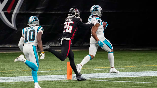 Oct 11, 2020; Atlanta, Georgia, USA; Carolina Panthers wide receiver DJ Moore (12) scores a touchdown behind Atlanta Falcons cornerback Isaiah Oliver (26) during the first half at Mercedes-Benz Stadium. Mandatory Credit: Dale Zanine-USA TODAY Sports