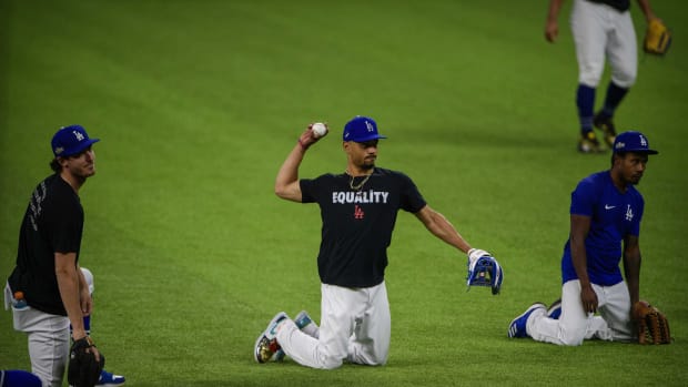 Oct 11, 2020; Arlington, TX, USA; Los Angeles Dodgers right fielder Mookie Betts (50) throws the ball as the Dodgers work out at Globe Life Park. Mandatory Credit: Jerome Miron-USA TODAY Sports
