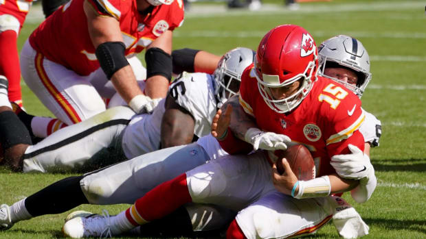 Oct 11, 2020; Kansas City, Missouri, USA; Kansas City Chiefs quarterback Patrick Mahomes (15) is sacked by Las Vegas Raiders defensive end Maxx Crosby (98) during the second half at Arrowhead Stadium. Mandatory Credit: Denny Medley-USA TODAY Sports