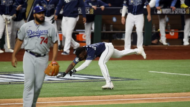 Oct 24, 2020; Arlington, Texas, USA; Tampa Bay Rays designated hitter Randy Arozarena (56) stumbles before scoring the winning run as Los Angeles Dodgers relief pitcher Kenley Jansen (74) looks on during the ninth inning of game four of the 2020 World Series at Globe Life Field. Mandatory Credit: Tim Heitman-USA TODAY Sports