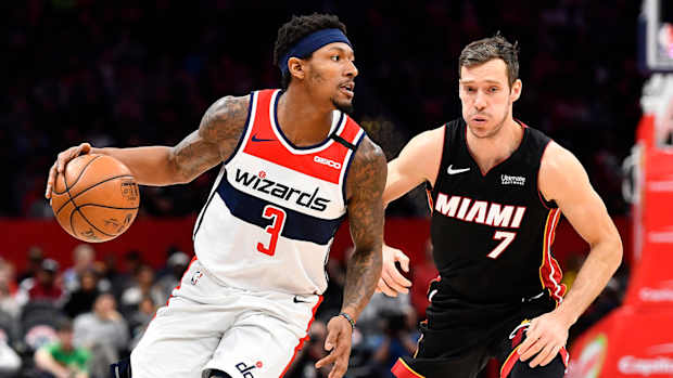 Washington Wizards guard Bradley Beal dribbles past Miami Heat guard Goran Dragic.