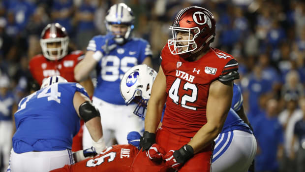 Aug 29, 2019; Provo, UT, USA; Utah Utes defensive end Mika Tafua (42) reacts to a sack on Brigham Young Cougars quarterback Zach Wilson (1) in the second quarter at LaVell Edwards Stadium.