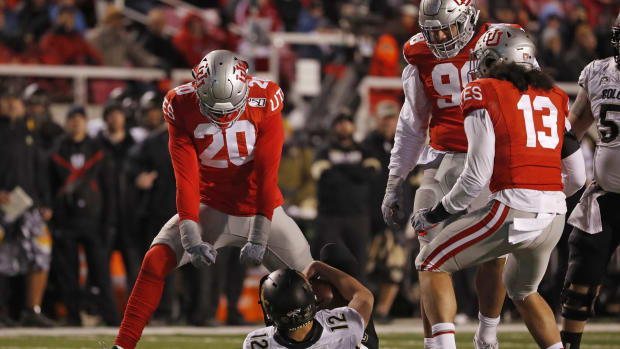 Nov 30, 2019; Salt Lake City, UT, USA; Utah Utes linebacker Devin Lloyd (20) reacts after taking down Colorado Buffaloes quarterback Steven Montez (12) in the fourth quarter at Rice-Eccles Stadium.