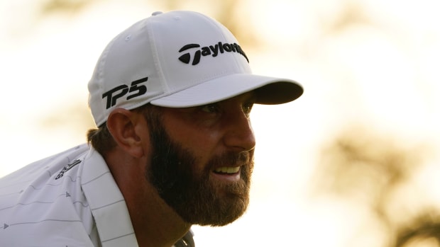 Dustin Johnson follows his shot from the 18th tee during the third round of The Masters golf tournament