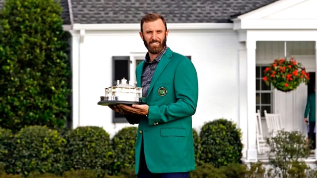 Dustin Johnson celebrates with the Masters Trophy after winning The Masters golf tournament