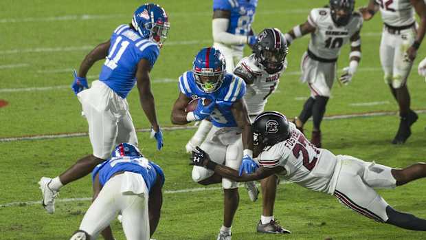 Nov 14, 2020; Oxford, Mississippi, USA; Mississippi Rebels wide receiver Elijah Moore (8) carries the ball against South Carolina Gamecocks defensive back Jaylan Foster (27) during the first half at Vaught-Hemingway Stadium. Mandatory Credit: Justin Ford-USA TODAY Sports