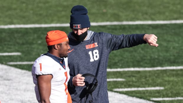 Illinois Fighting Illini quarterback Isaiah Williams (1) talks with quarterback Brandon Peters (18) during the first half against the Rutgers Scarlet Knights at SHI Stadium.