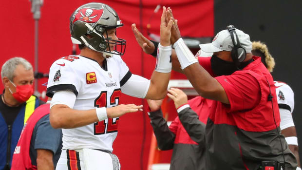 Oct 4, 2020; Tampa, Florida, USA; Tampa Bay Buccaneers quarterback Tom Brady (12) celebrates on the sideline against the Los Angeles Chargers in the third quarter of a NFL game at Raymond James Stadium. Mandatory Credit: Kim Klement-USA TODAY Sports