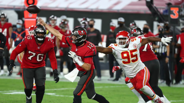 Nov 29, 2020; Tampa, Florida, USA; Tampa Bay Buccaneers quarterback Tom Brady (12) throws as Kansas City Chiefs defensive tackle Chris Jones (95) moves in during the second half at Raymond James Stadium. Mandatory Credit: Kim Klement-USA TODAY Sports