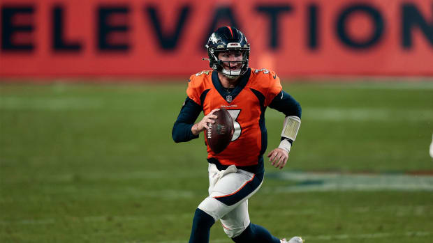 Nov 22, 2020; Denver, Colorado, USA; Denver Broncos quarterback Drew Lock (3) scrambles with the ball against the Miami Dolphins in the fourth quarter at Empower Field at Mile High.