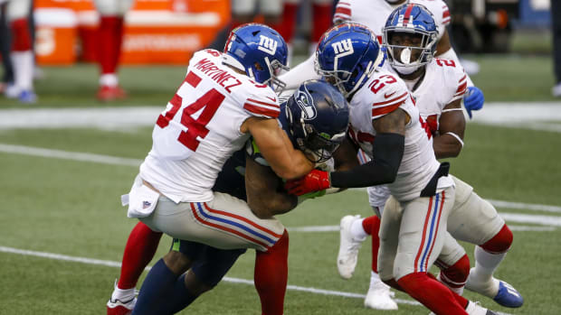 Dec 6, 2020; Seattle, Washington, USA; New York Giants inside linebacker Blake Martinez (54) and free safety Logan Ryan (23) tackle Seattle Seahawks running back Chris Carson (32) during the fourth quarter at Lumen Field.