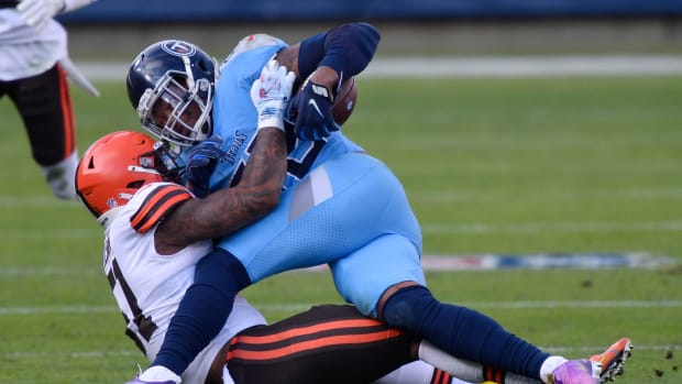 Tennessee Titans running back Derrick Henry (22) is tackled by Cleveland Browns outside linebacker Mack Wilson (51) during the third quarter at Nissan Stadium Sunday, Dec. 6, 2020 in Nashville, Tenn. Aab0755