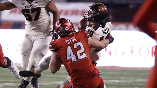 Dec 5, 2020; Salt Lake City, Utah, USA; Utah Utes defensive end Mika Tafua (42) sacks Oregon State Beavers quarterback Chance Nolan (10) on the final drive of the game at Rice-Eccles Stadium.
