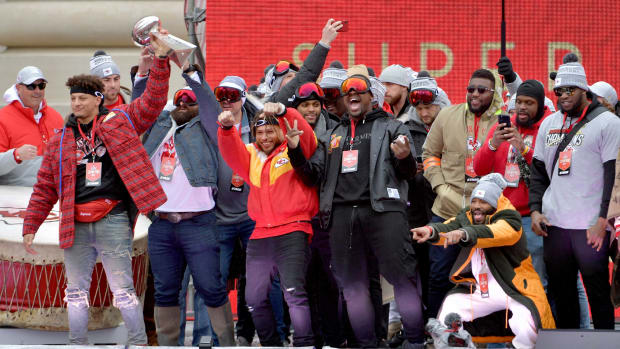Feb 5, 2020; Kansas City, Missouri, USA; Kansas City Chiefs quarterback Patrick Mahomes (15) holds the Lombardi trophy as team members celebrate on stage during the Champions Rally. Mandatory Credit: Denny Medley-USA TODAY Sports