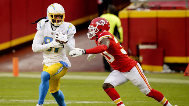 Jan 3, 2021; Kansas City, Missouri, USA; Los Angeles Chargers wide receiver Mike Williams (81) catches a pass against Kansas City Chiefs cornerback Deandre Baker (30) during the first half at Arrowhead Stadium. Mandatory Credit: Jay Biggerstaff-USA TODAY Sports