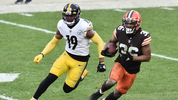 Jan 3, 2021; Cleveland, Ohio, USA; Cleveland Browns cornerback M.J. Stewart (36) returns an interception as Pittsburgh Steelers wide receiver JuJu Smith-Schuster (19) pursues during the second half at FirstEnergy Stadium. Mandatory Credit: Ken Blaze-USA TODAY Sports