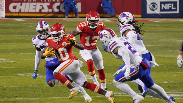 Jan 24, 2021; Kansas City, MO, USA; Kansas City Chiefs wide receiver Tyreek Hill (10) runs the ball against Buffalo Bills free safety Jordan Poyer (21) during the third quarter in the AFC Championship Game at Arrowhead Stadium. Mandatory Credit: Denny Medley-USA TODAY Sports