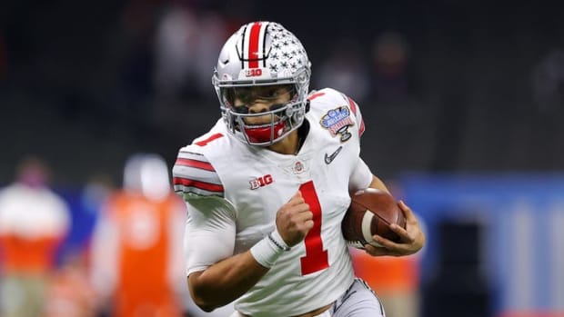 Justin Fields runs the ball against the Clemson Tigers