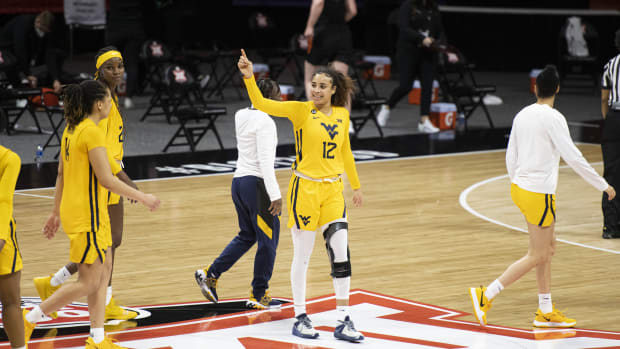 March 13, 2021; Kansas City, MO, USA; West Virginia Mountaineers forward Esmery Martinez (12) smiles after defeating the Oklahoma State Cowgirls at Municipal Auditorium.
