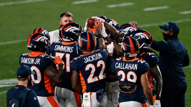 Denver Broncos cornerback Duke Dawson Jr. (20) and free safety Justin Simmons (31) and strong safety Kareem Jackson (22) and cornerback Bryce Callahan (29) with teammates before the game against the Tennessee Titans at Coors Field.