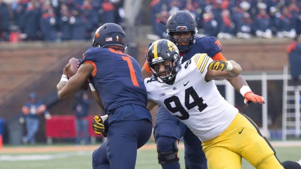 Nov 17, 2018; Champaign, IL, USA; Iowa Hawkeyes defensive end A.J. Epenesa (94) sacks Illinois Fighting Illini quarterback AJ Bush Jr. (1) during the second quarter at Memorial Stadium.