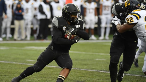 Nov 23, 2019; Nashville, TN, USA; Vanderbilt Commodores running back Ke'Shawn Vaughn (5) runs for a short gain during the first half against the East Tennessee State Buccaneers at Vanderbilt Stadium.