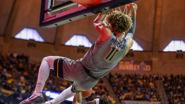 West Virginia Mountaineers forward Emmitt Matthews Jr. (11) dunks the ball during the second half against the Baylor Bears at WVU Coliseum.