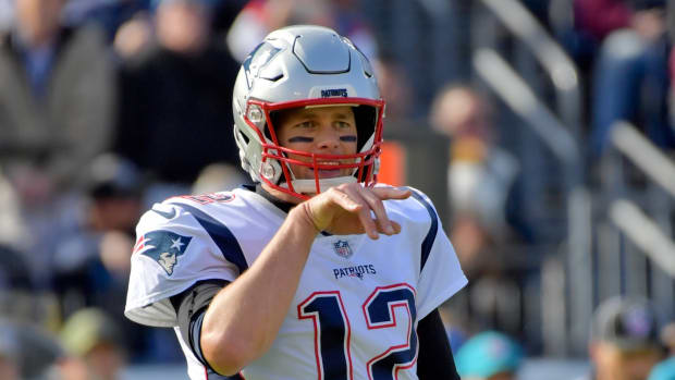 New England Patriots quarterback Tom Brady (12) signals from the line against the Tennessee Titans during the first half at Nissan Stadium.