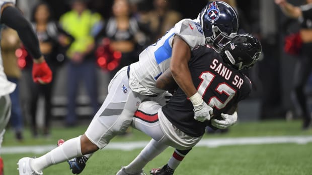 Tennessee Titans linebacker Reggie Gilbert (93) tackles Atlanta Falcons wide receiver Mohamed Sanu (12) during the second half at Mercedes-Benz Stadium.