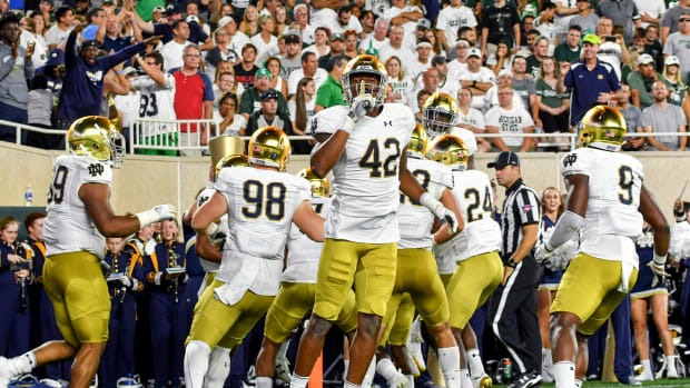 Sep 23, 2017; East Lansing, MI, USA; Notre Dame Fighting Irish defensive lineman Julian Okwara (42) gestures to the MSU crowd after Notre Dame scored a touchdown on an interception return in the first quarter against the Michigan State Spartans at Spartan Stadium.